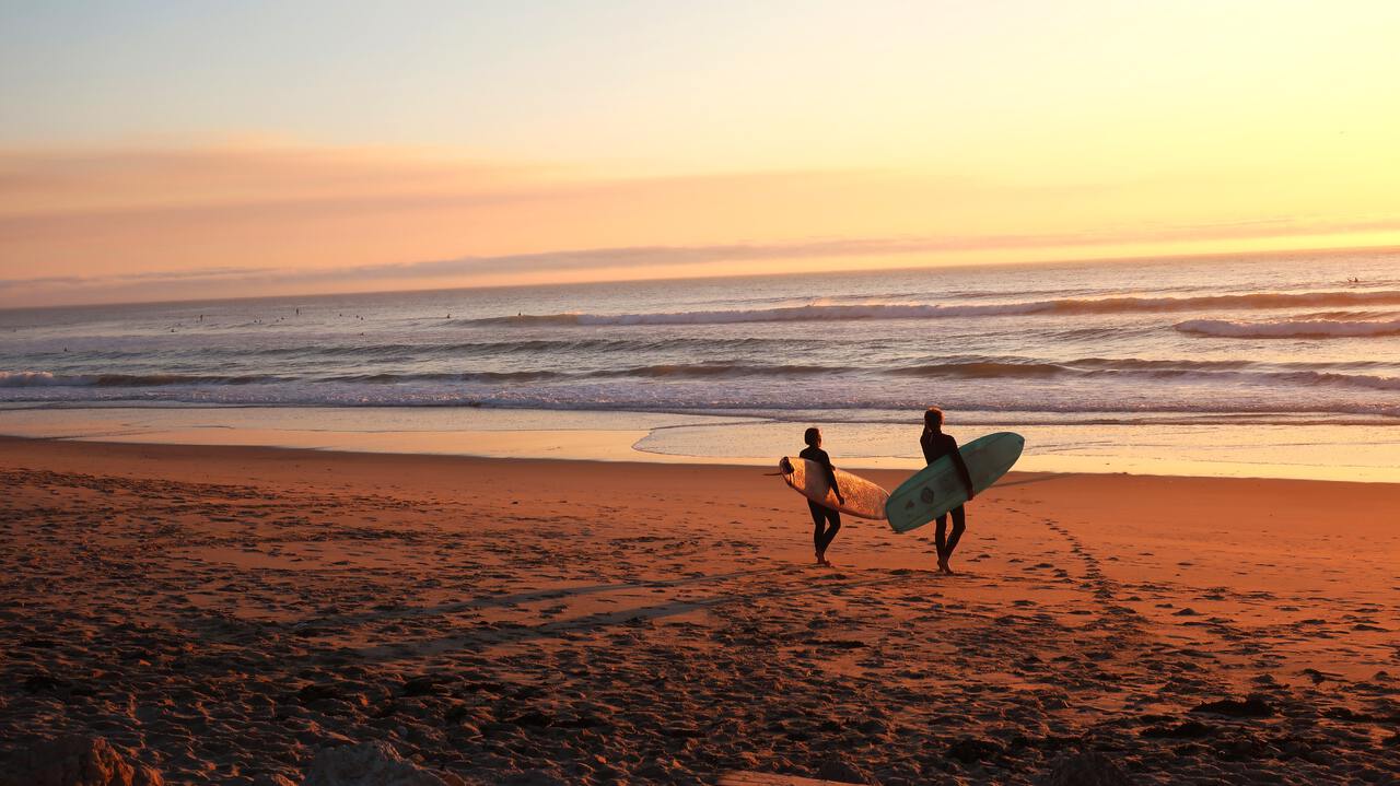 Surfers getting ready for the morning waves near Fishtral beach