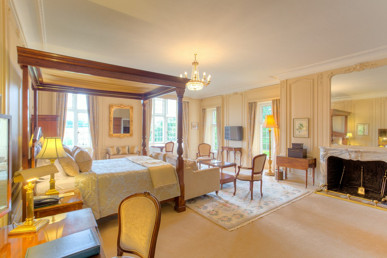 Spacious four-poster bed room , Rushton Hall Hotel, Northamptonshire